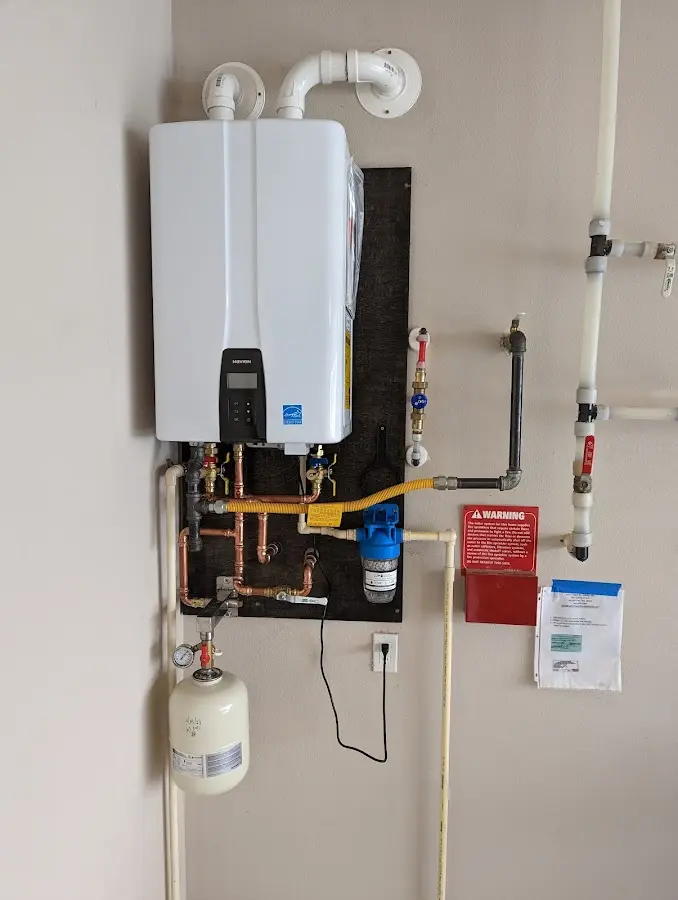 Professional plumber installing copper piping in a New Bern home